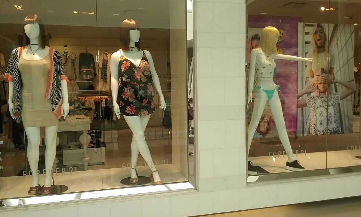 Shop bald dummy fashion mannequin in store boutique shop window
