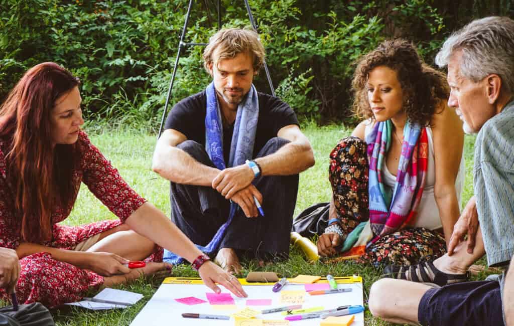 Group of diverse people discussing outdoors at a community gathering.