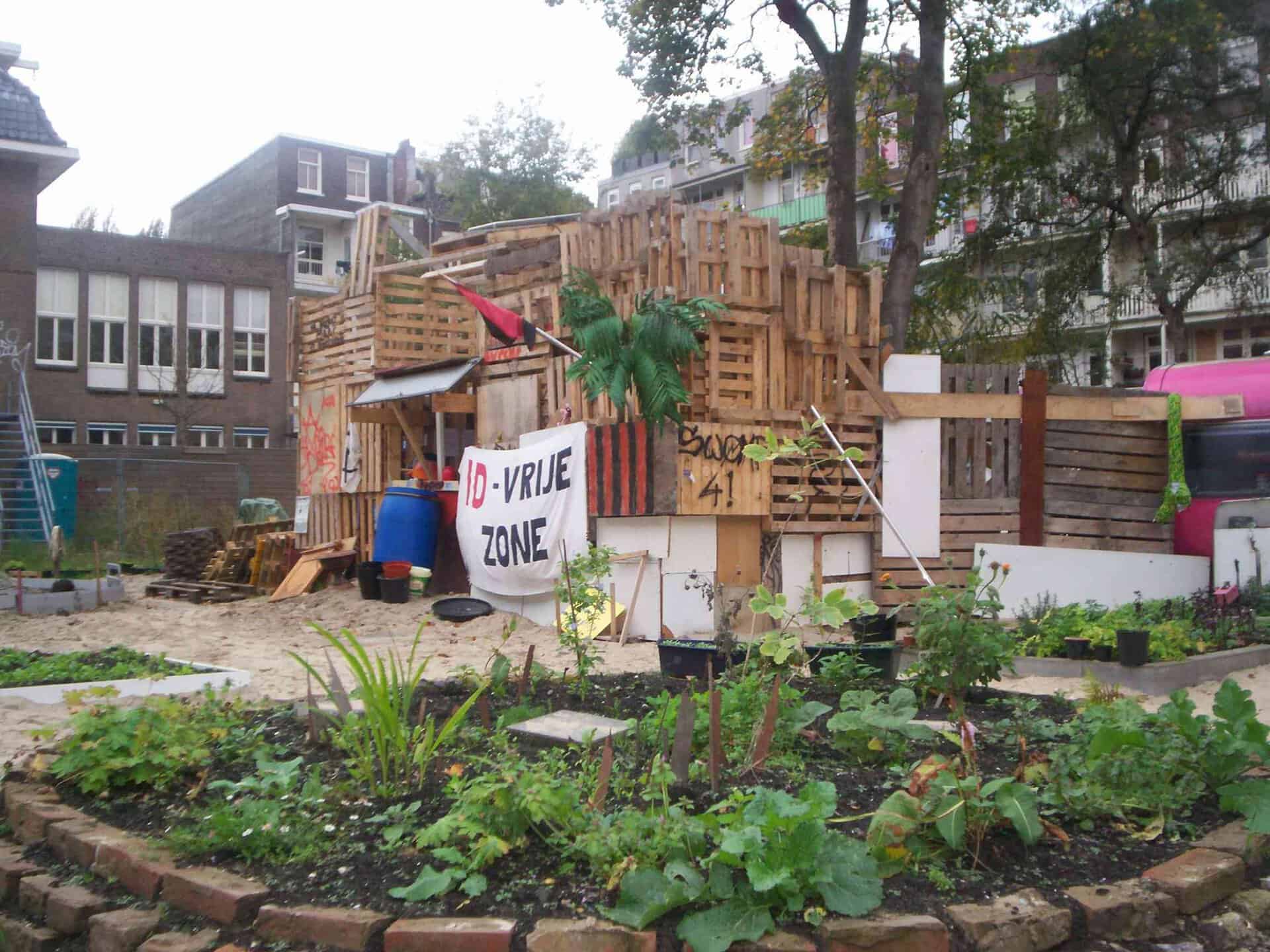 Community-built wooden structure with garden in urban setting.