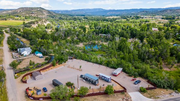 Aerial view of MarLin Village Tiny Home Community with green landscape and tiny houses.