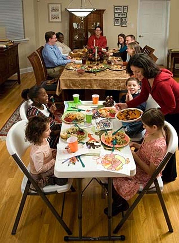 Family gathering enjoying a festive meal at a community dinner table.