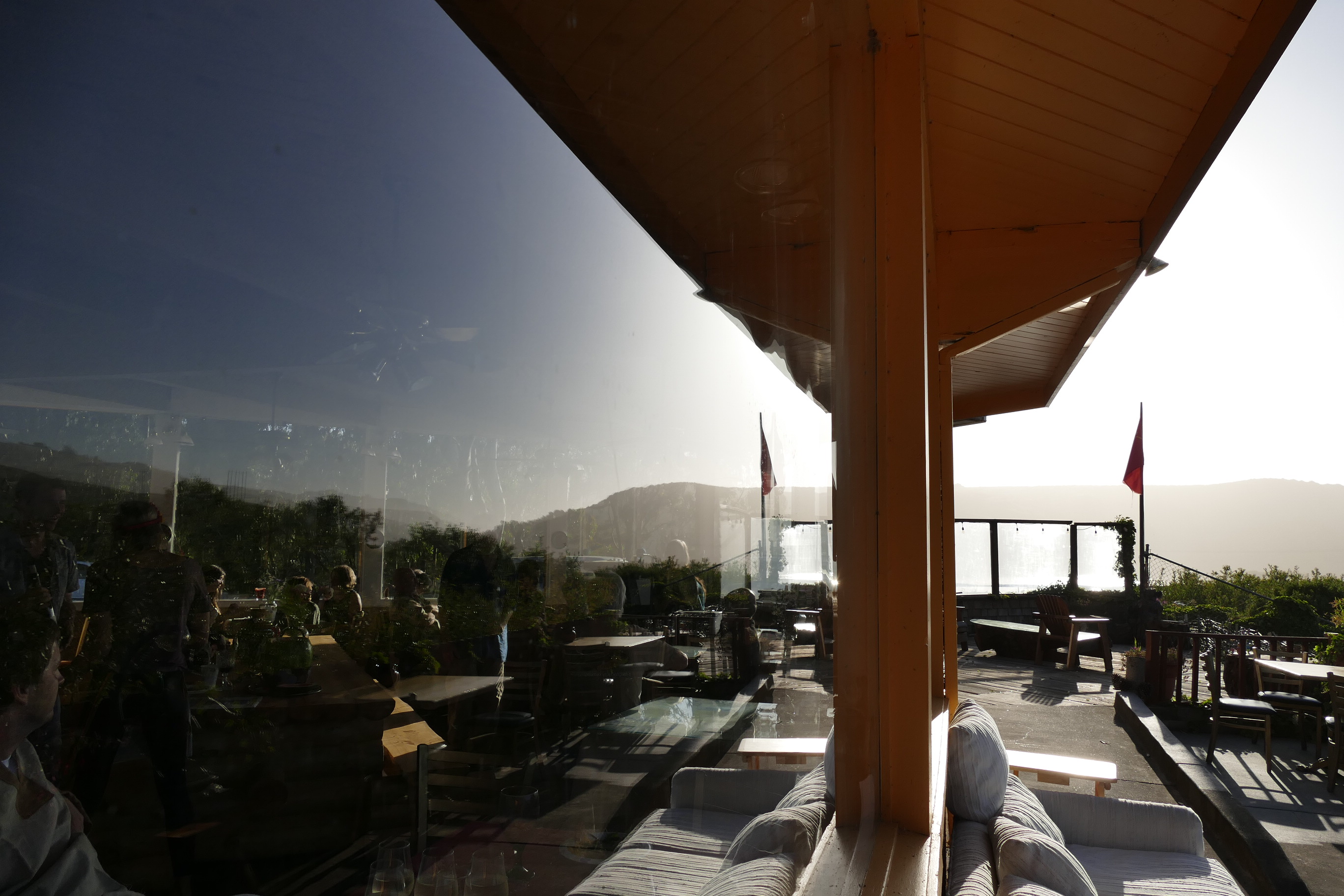 Modern outdoor terrace with seating and scenic mountain view at a community center.