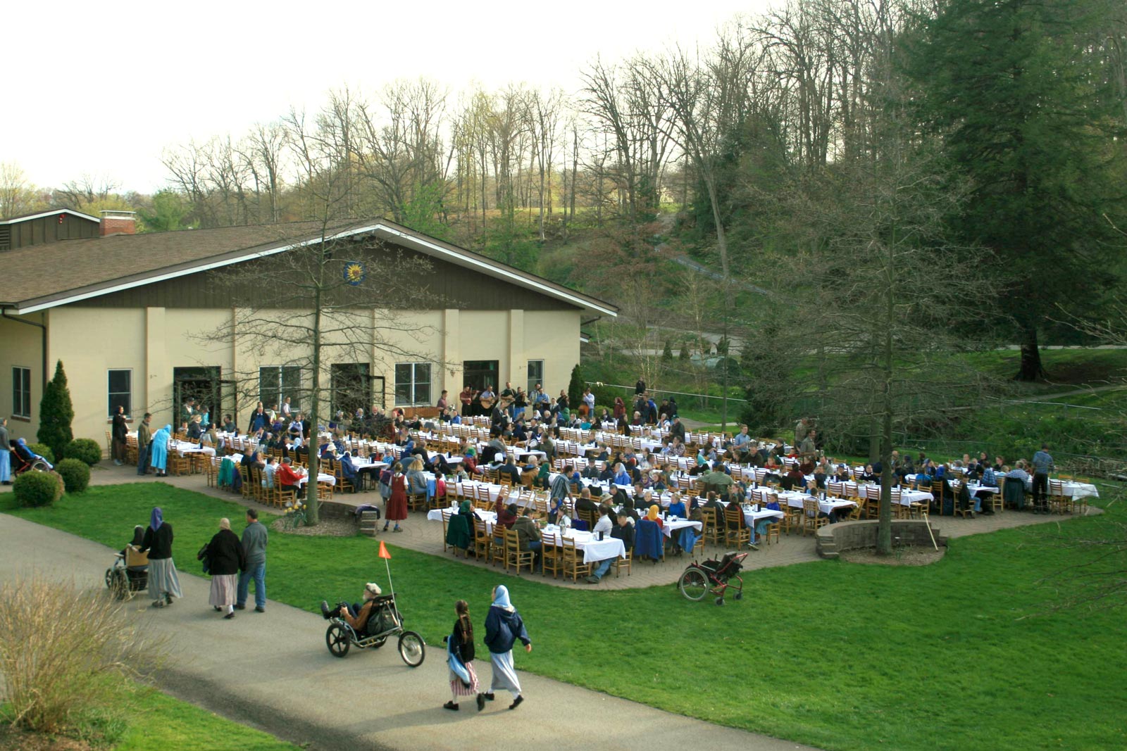 Large outdoor community gathering at Foundation for Intentional Community event.