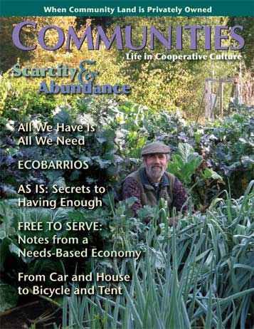 Community garden with lush vegetables and a smiling man in a hat.