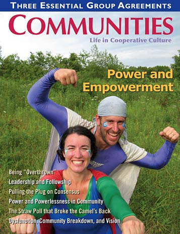 Two smiling people flex their muscles outdoors, celebrating community empowerment.