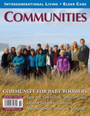 Group of diverse people standing outdoors near the coast, smiling at the camera.