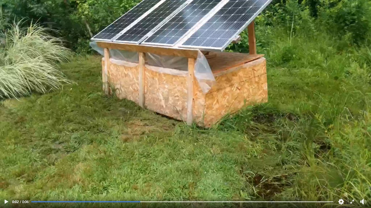 Eco-friendly solar-powered compost bin in a green outdoor setting.