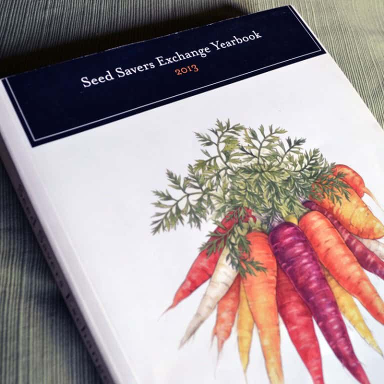 Seed Savers Exchange Yearbook 2013 with colorful carrots illustration.