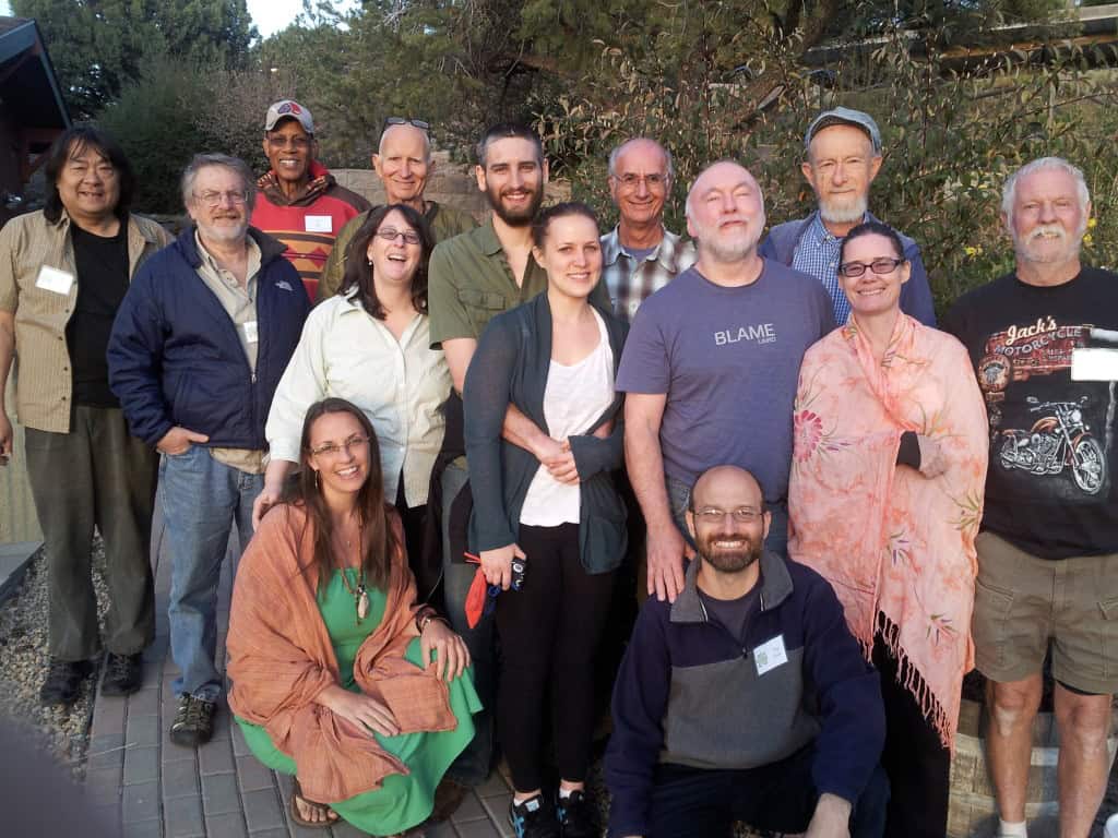 Group of diverse adults smiling outdoors at Foundation for Intentional Community event.