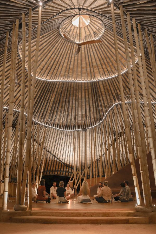 Interior view of a sustainable bamboo community space with a domed ceiling.