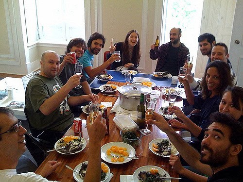 Group of diverse people enjoying a meal together at a community gathering.