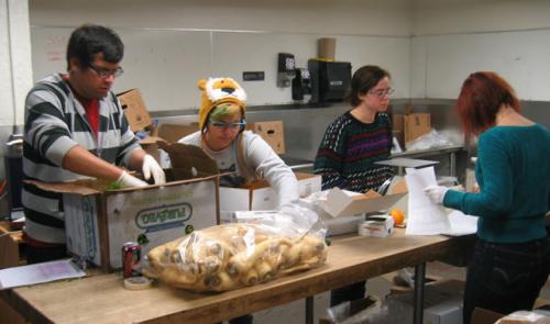 People working together in a community kitchen or food preparation area.
