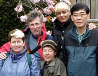Group of diverse people smiling outdoors at a community event.