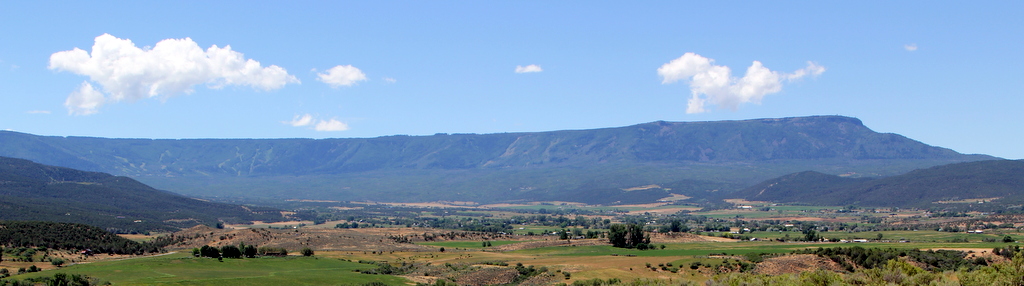 Scenic view of mountains and open landscape in a rural area.