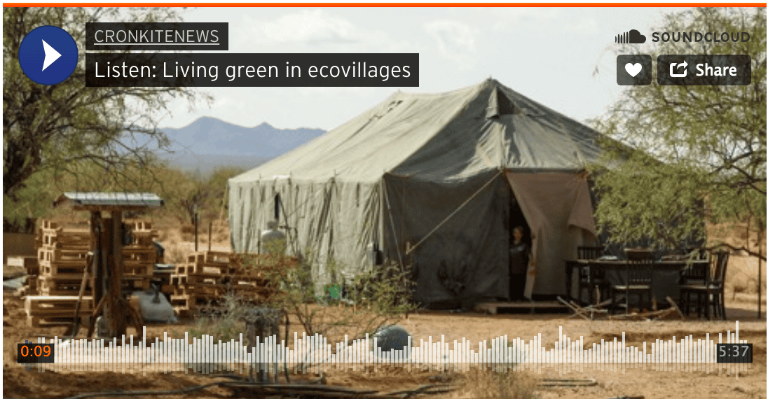 Eco-village tent in a desert landscape with mountains in the background.