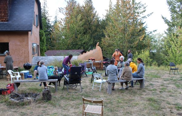 Community gathering outdoors at Foundation for Intentional Community event.
