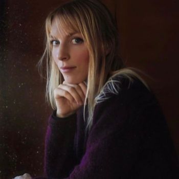 Portrait of a woman with blonde hair and thoughtful expression.