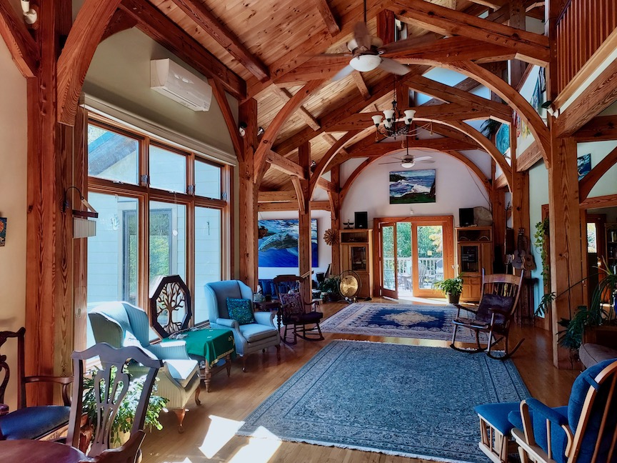 Spacious interior of a retreat with wooden beams and large windows in Virginia.