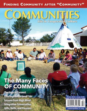 Community gathering outdoors with diverse participants sitting in a circle near a teepee.