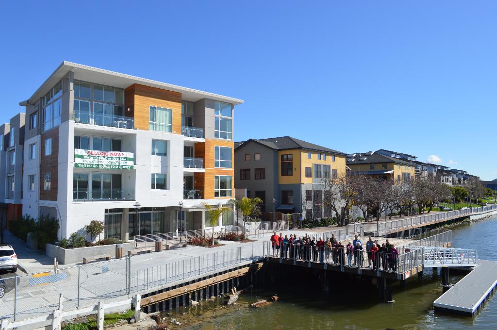 Modern residential buildings near a waterway in Oakland, CA.