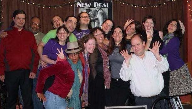 Group of diverse people smiling and celebrating at an event.