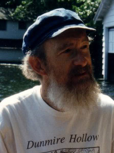 Man with a beard and cap outdoors at Foundation for Intentional Community event.