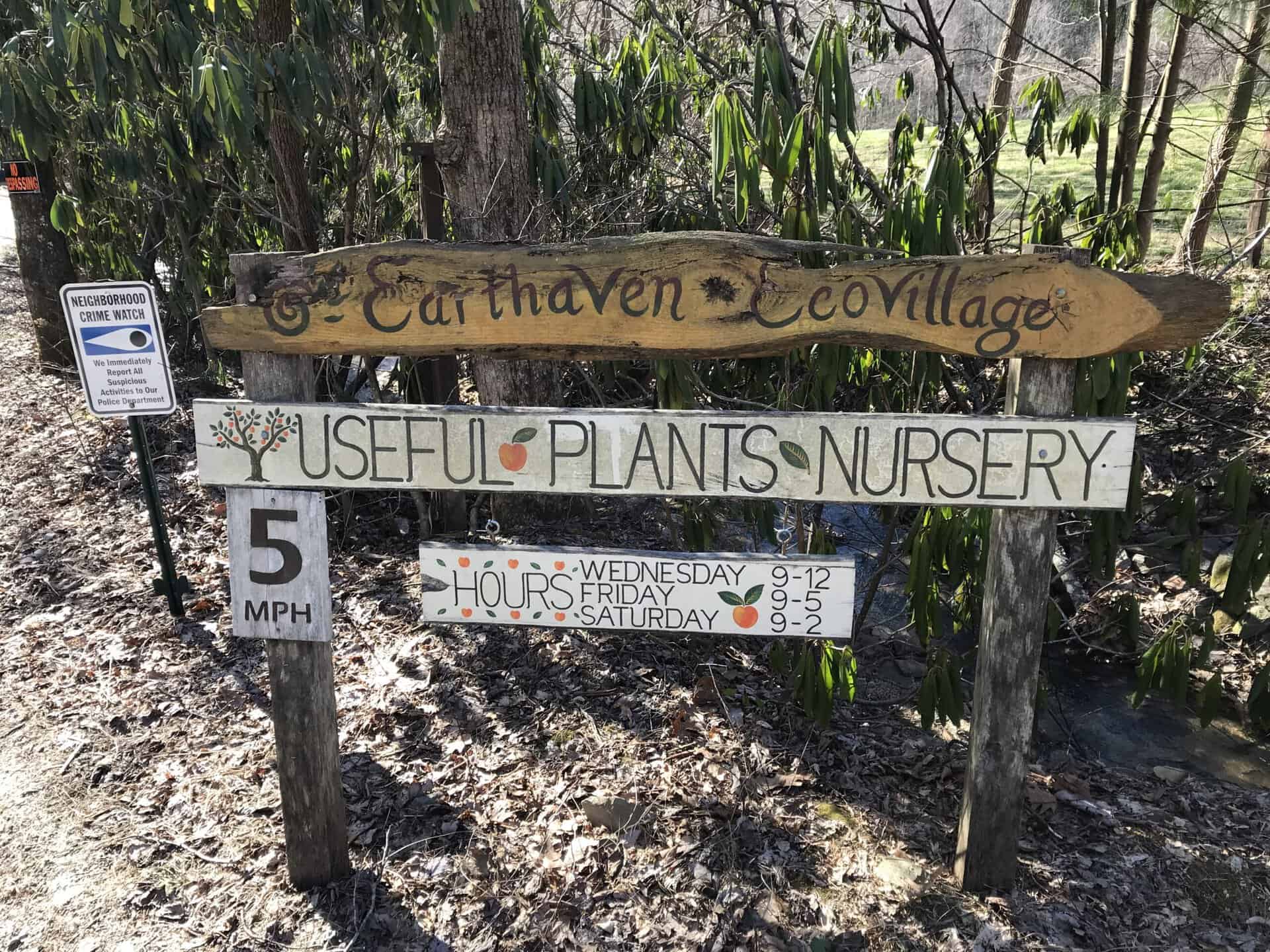 Sign for Earthaven Ecovillage with nursery hours and speed limit.