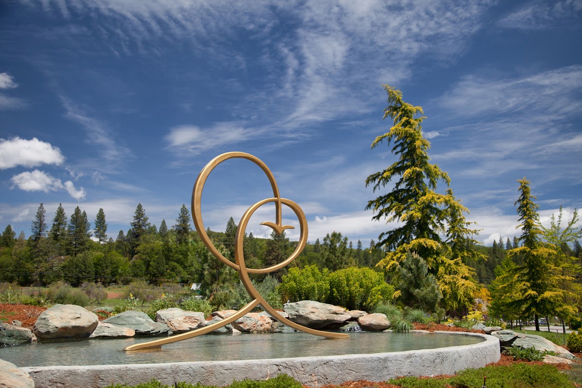 Sculpture with circular loops near a river at Ananda Village.