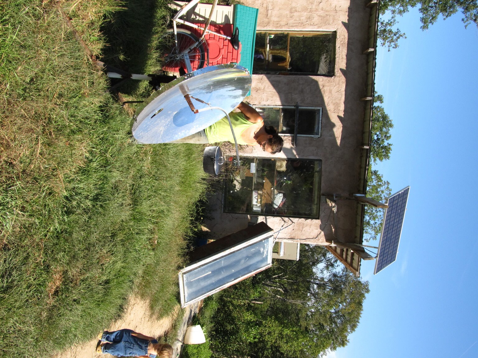 Person working on solar water heater at Living Energy Farm.