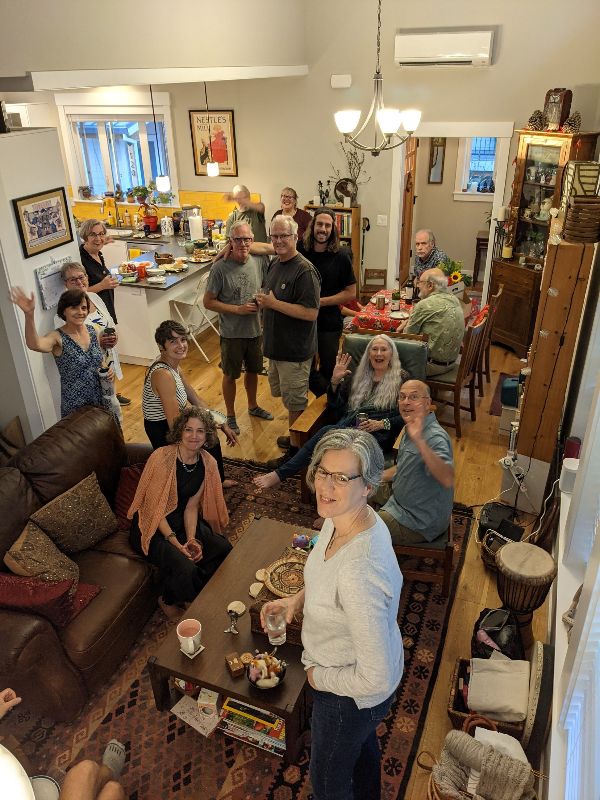 Community gathering at Evans Oaks Cottages with people enjoying a meal and socializing.