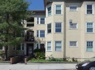 Multi-story residential building with multiple windows and balconies.