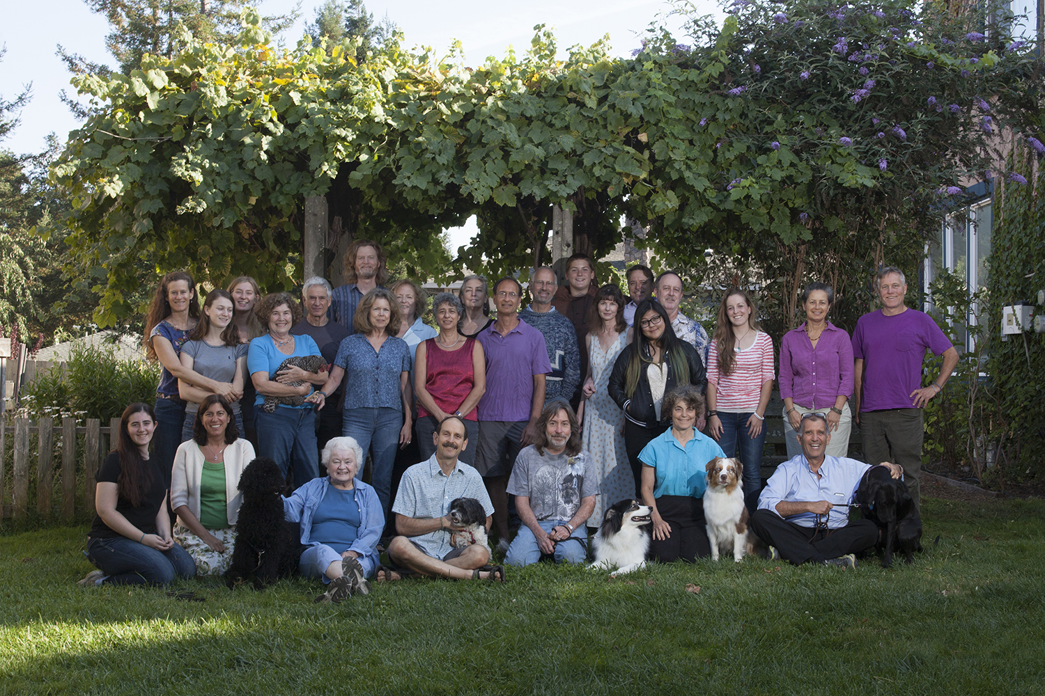 Group photo of community members and dogs at Foundation for Intentional Community event.