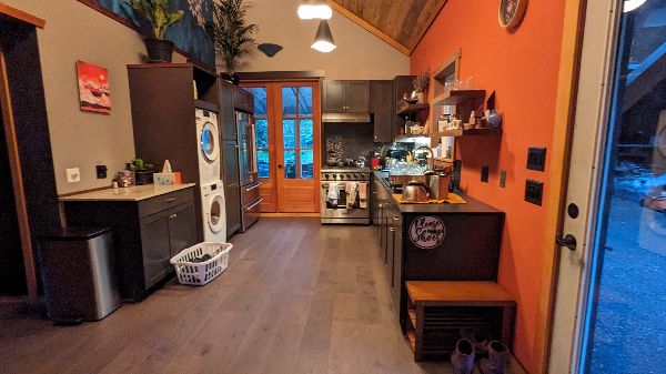 Cozy kitchen with warm orange walls and modern appliances in a community home.