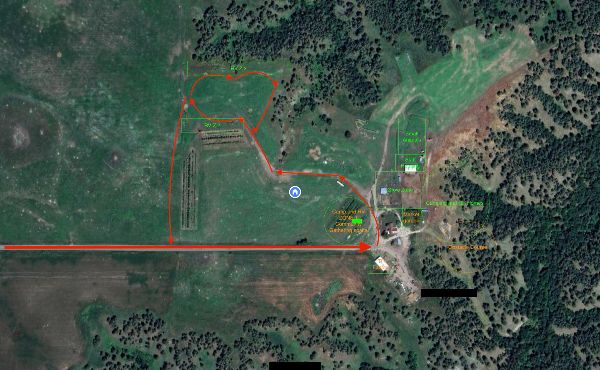 Aerial view of community land with pathways, buildings, and green spaces.