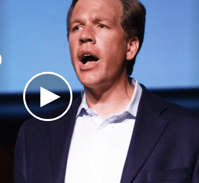 Man speaking passionately at a conference or event.