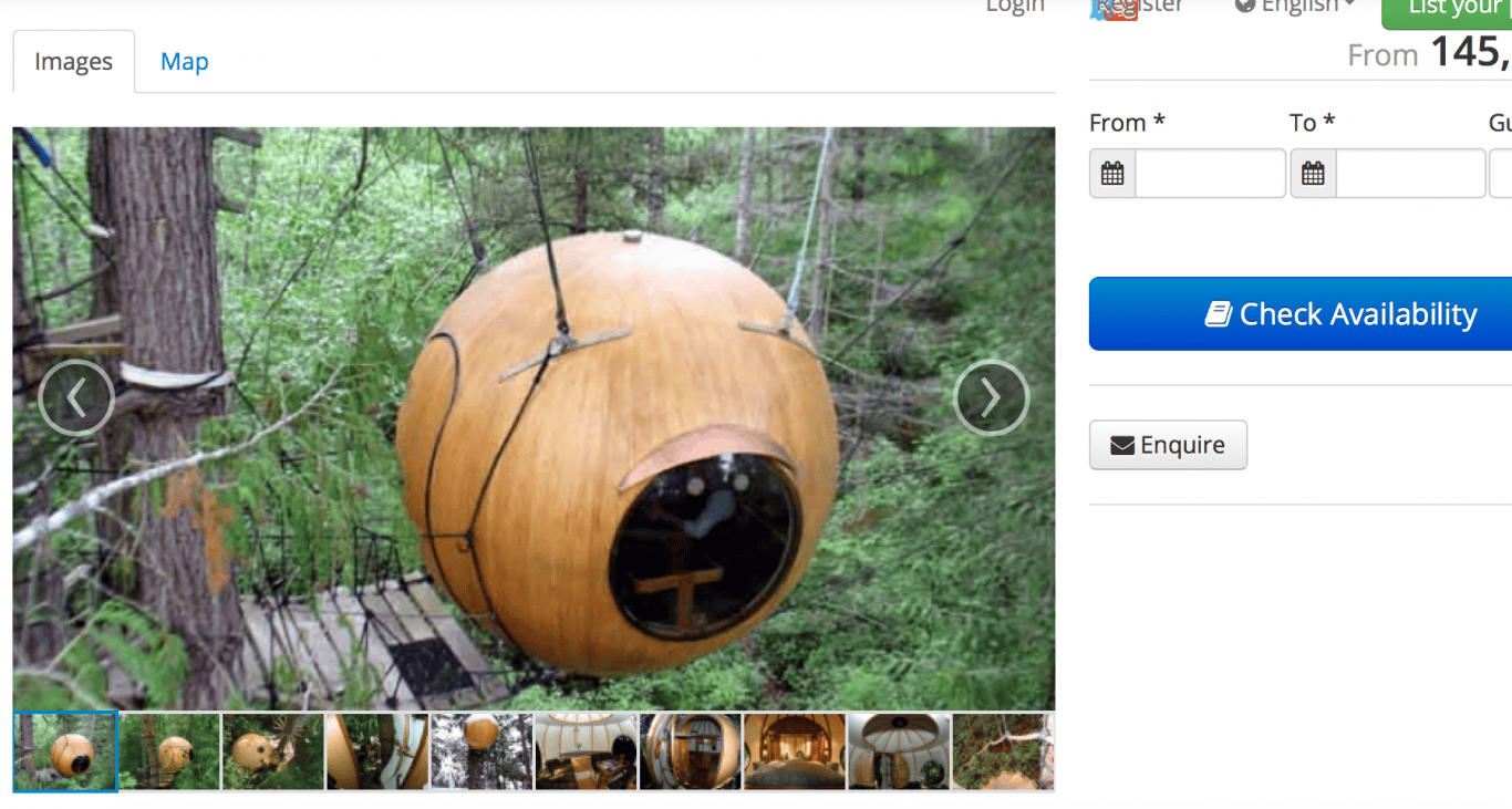 Wooden spherical tiny house with a window, set in a forest environment.