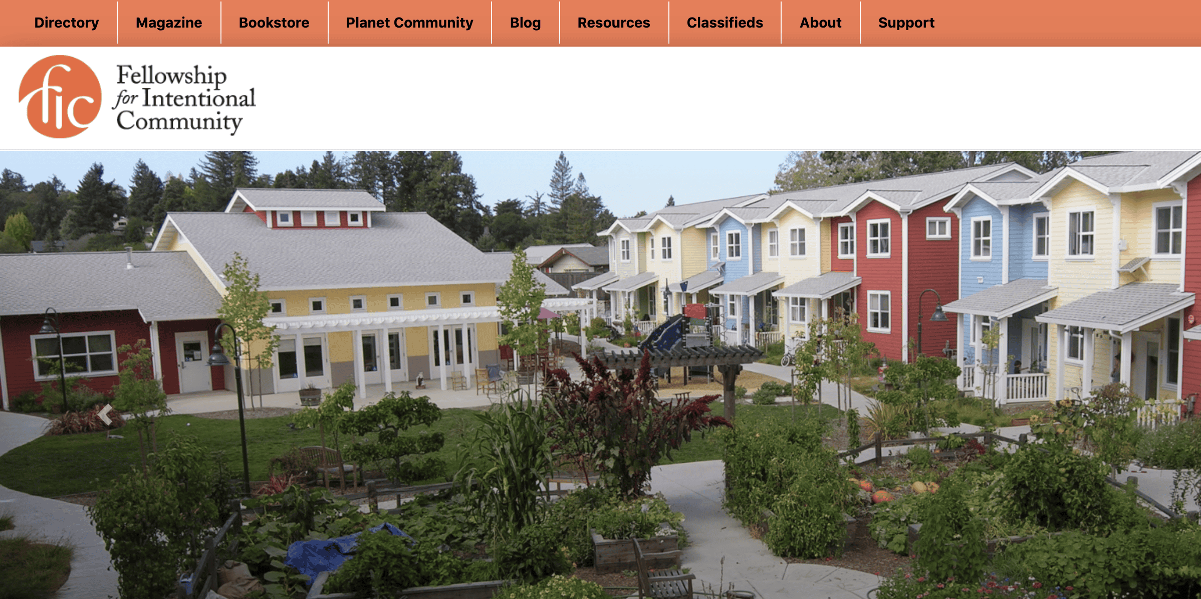 Colorful community houses in a lush green setting at the Foundation for Intentional Community.