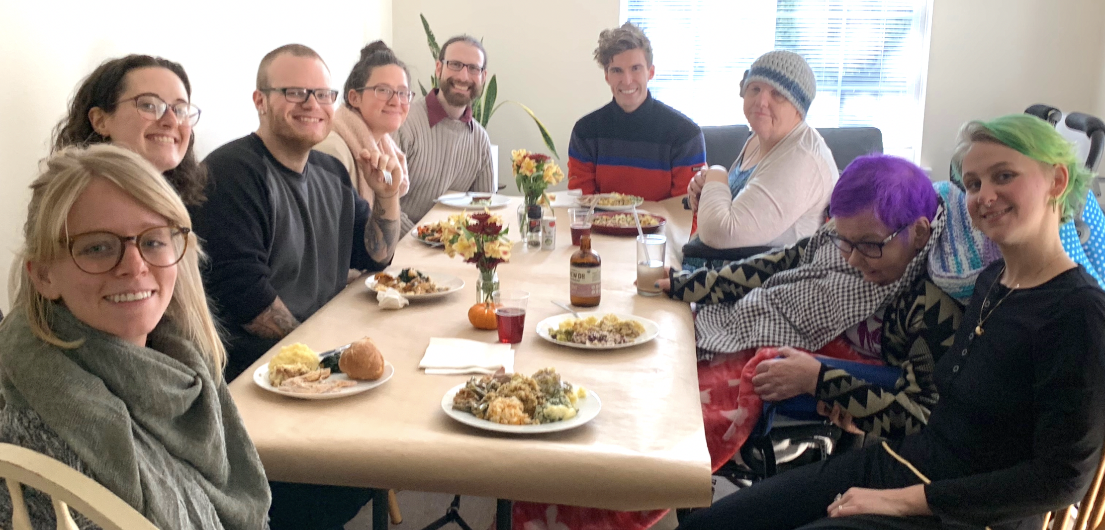 Group of diverse people enjoying a meal together at a community gathering.