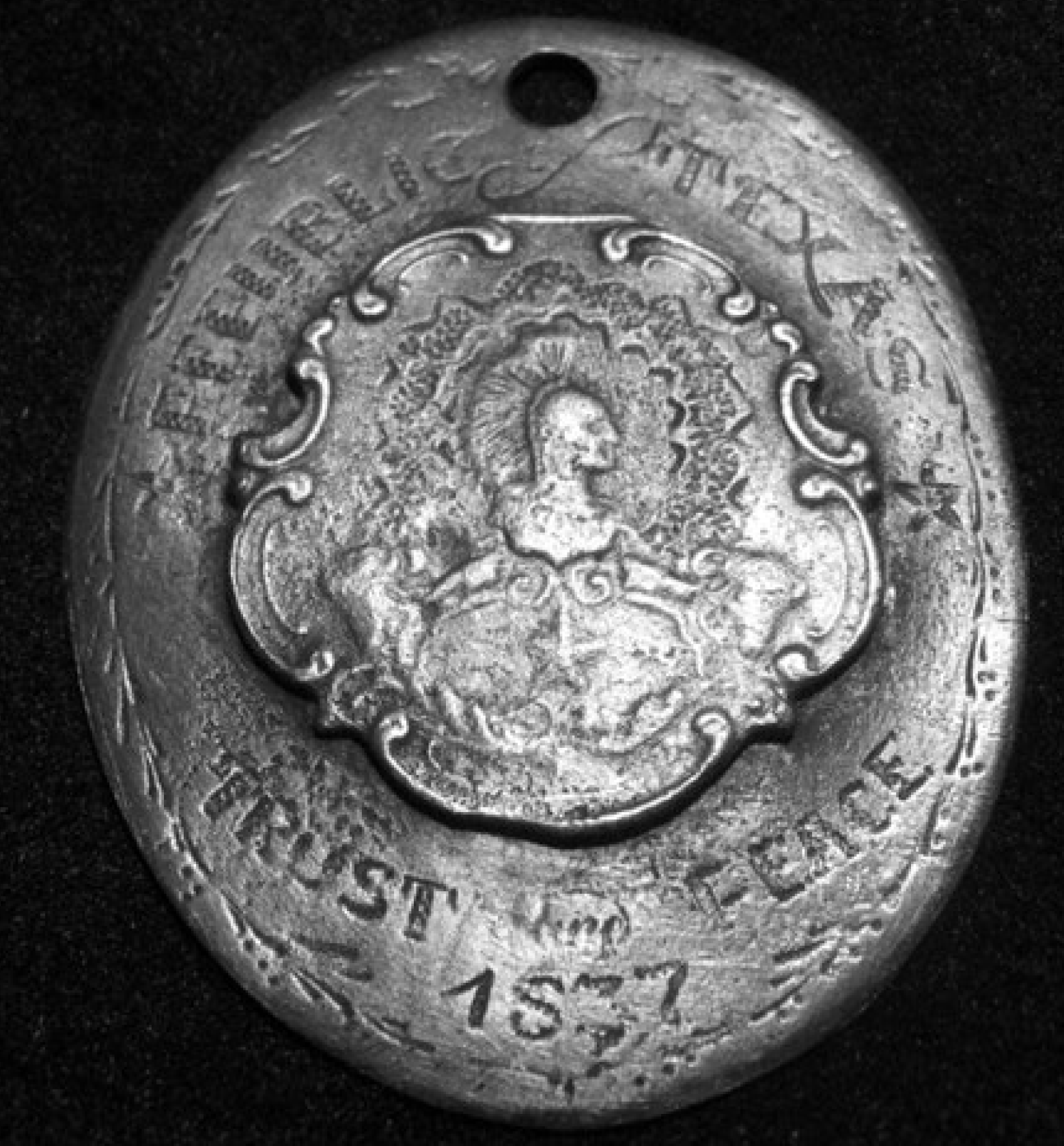Close-up of an antique silver coin from 1857 with detailed engravings.