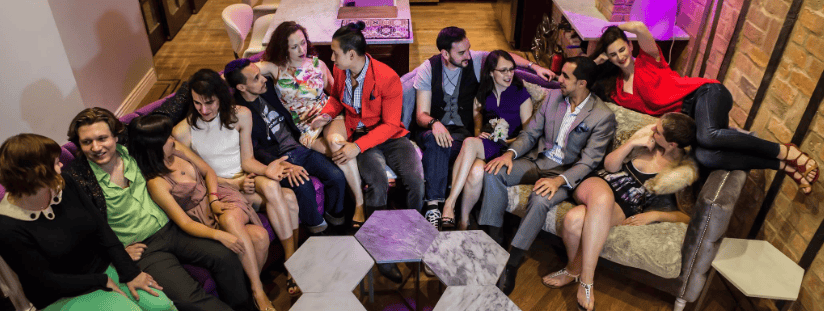 Group of diverse people socializing in a cozy indoor setting.