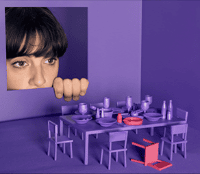 Close-up of a person's face peeking through a purple wall opening.