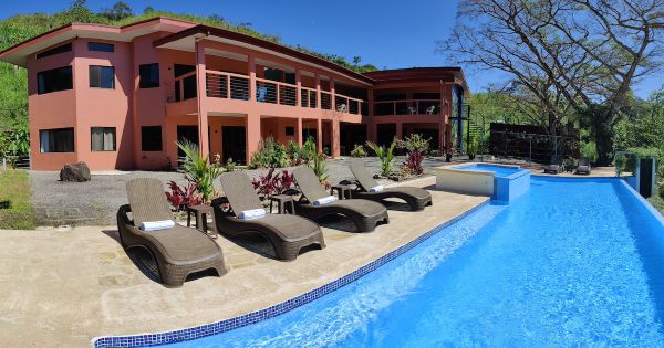 Luxury community house with pool and lounge chairs at Vista Mundo Conscious Community.