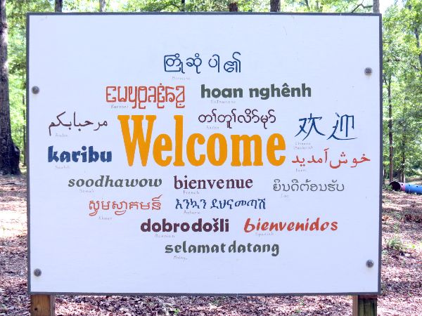 Welcome sign with 'Welcome' in multiple languages and scripts.