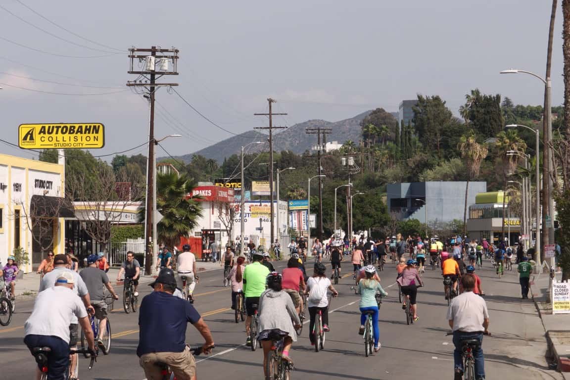 Cyclists and pedestrians enjoy a community bike event on city streets.