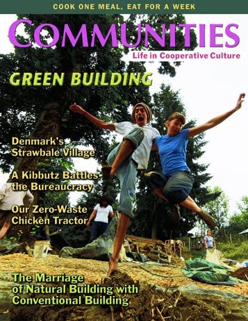 Children jumping and playing near a large tree in a sustainable community setting.