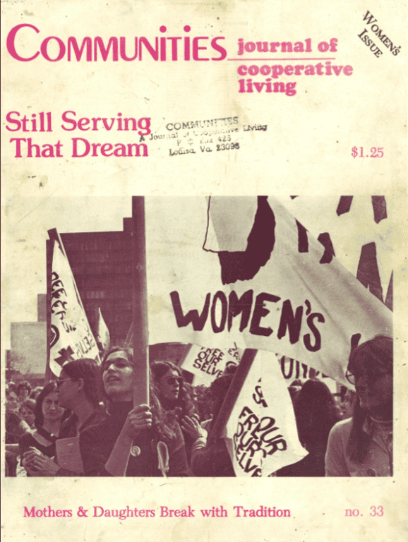 Women holding protest signs at a community event, promoting women's rights.