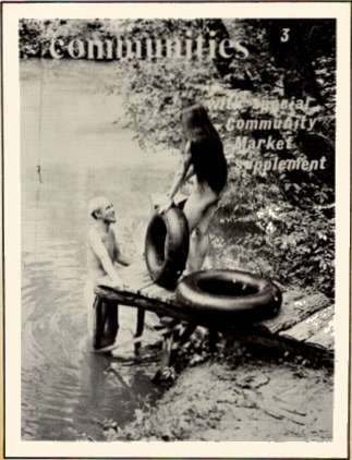 People by a lakeside with inner tubes, vintage black-and-white photo.