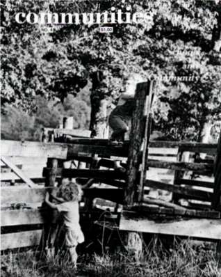 Children playing on a wooden playground structure in a park setting.
