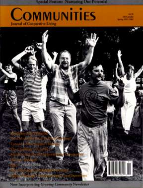 People celebrating outdoors, raising hands in unity and joy.