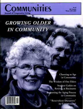 Older couple smiling, embracing, in a community setting.